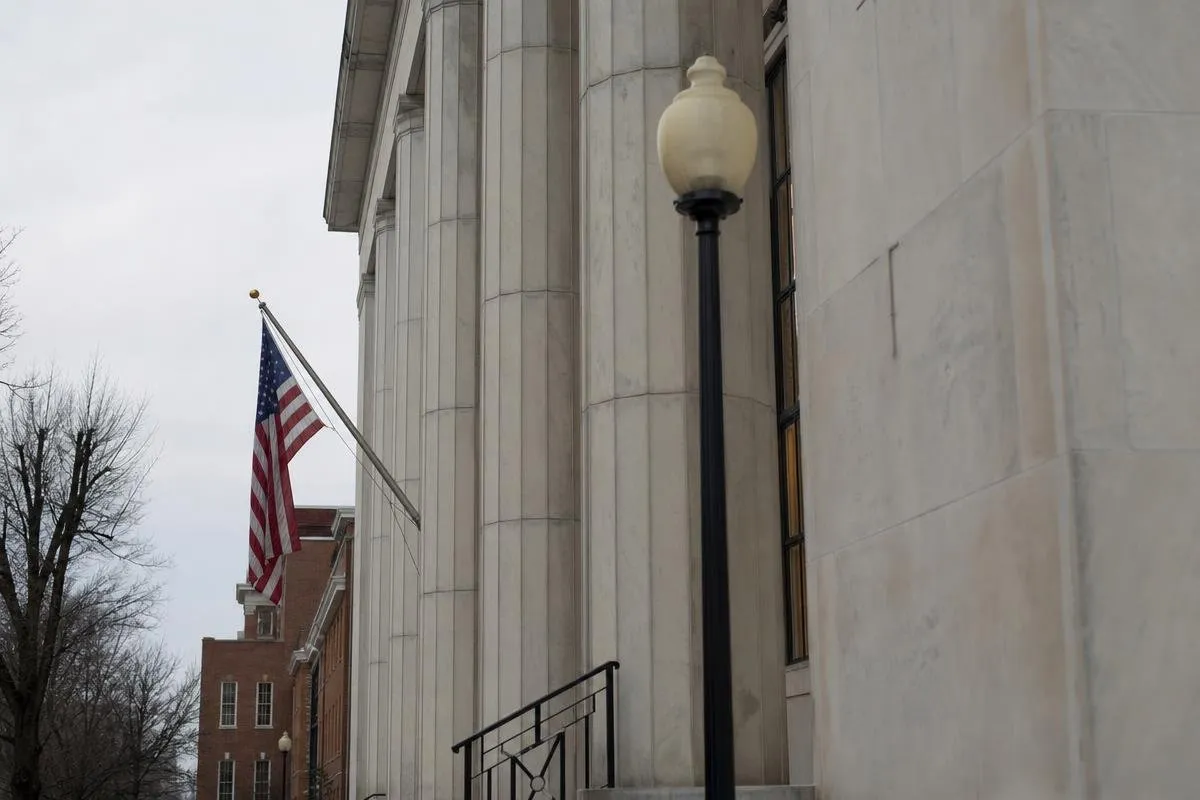 American flag outside a stone courthouse building